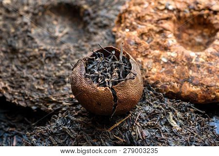 Puer Raw Tea. Pu-erh Orange Tea And Some Cakes On Background. Traditional Chinese Beverage And Popul