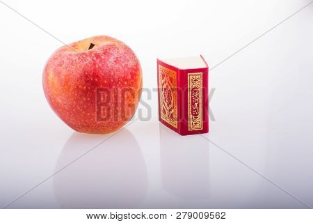 Red Apple And  Islamic Holy Book Quran In Mini Size