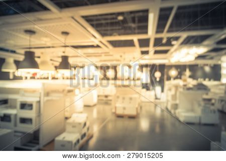 Blurry Background Variety Of Table, Ceiling, Floor Lamps At Furn