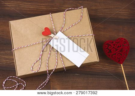 Top View Cardboard Box With Clothpin With Red Heart And Empty White Label With Place For Text And Re