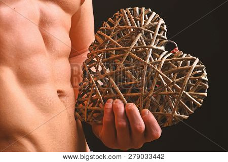Athletes Body In Close Up, Hand Holding Big Rattan Heart