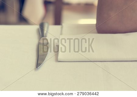 Closeup Of Knife And Napking On A Dinning Table.