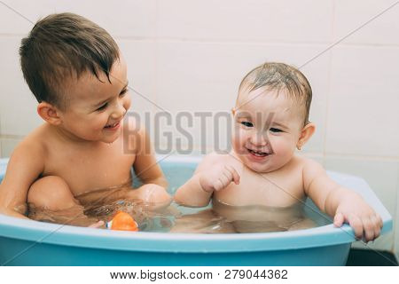 Children, Brother And Sister In The Bathroom Swimming, Playing Splashing