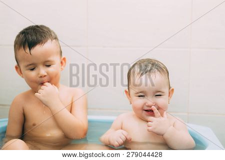 Children, Brother And Sister In The Bathroom Swimming, Playing Splashing