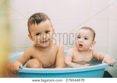 Children, Brother And Sister In The Bathroom Swimming, Playing Splashing