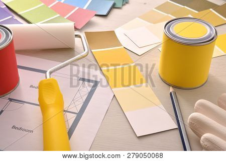 Tools And Material On Designer Interior Table With Painting Project. Elevated View. Horizontal Compo