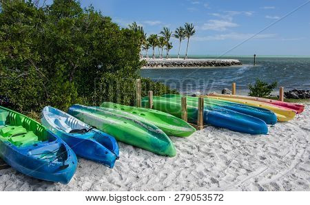 Kayaks On A Florida Beach:  A Row Of Rental Kayaks Lines The Shore Of An Ocean Inlet At A Park In Th