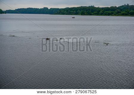Daugava River Near Koknese. View Of The Daugava River,  Boat With Anglers In The Distance. Latvian L