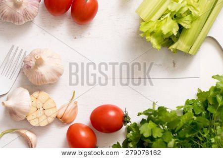 Fresh Vegetable Plate. Cherry Tomatoes On A White Antique Wooden Background, A Cutting Board Of Cele