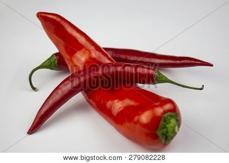 Red Hot Chili Pepper. Texture Background Close Landscape. Against The Background Of Red Hot Chili Pe