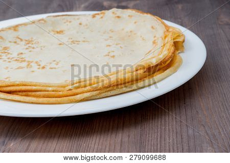 Fried Tasty Thin Slapjack On Wooden Background