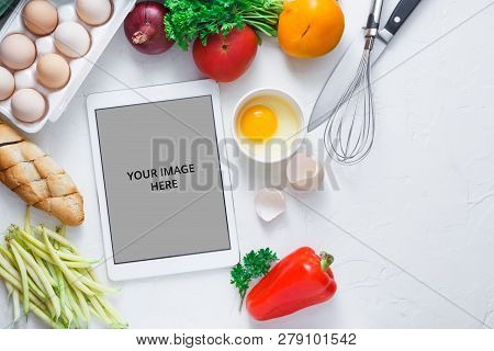 Cooking Concept, Tablet Computer And Breakfast Ingredient On White Bacjground