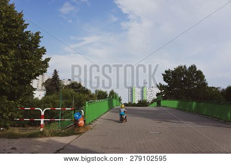 Poznan, Poland - July 10, 2018: Boy On Bicycle On A Bridge Crossing A Main Traffic Road By The Orla 