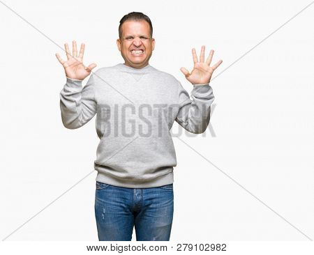 Middle age arab man wearing sport sweatshirt over isolated background showing and pointing up with fingers number ten while smiling confident and happy.