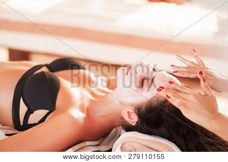 Spa Mask. Beautiful Woman Get Spa Mask On The Sunny Beach In Spa Salon Outdoor. High Quality. Scin C
