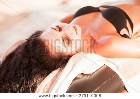 Spa Mask. Beautiful Woman Get Spa Mask On The Sunny Beach In Spa Salon Outdoor. High Quality. Scin C