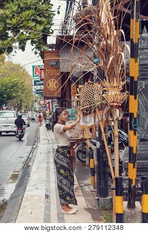 Bali, Indonesia - August 03 2015: A Woman Is Offering Sacrifice In A Small Home Temple In Kuta City,
