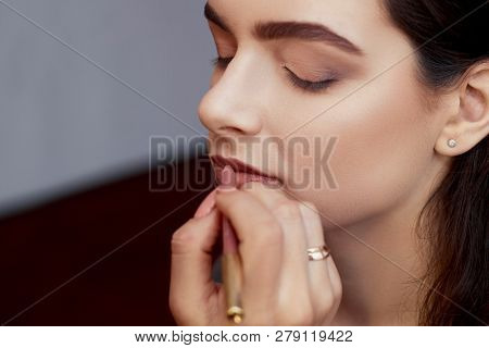Makeup.the Work Of A Professional Makeup Artist-beautician, Makes Makeup With A Brush On The Face Of