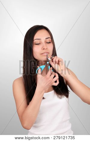 Stop Smoking Concept. Young Woman Cut Cigarettes With Scissors Happy Smiling. Focus On Hand, Scissor