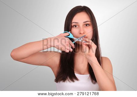 Stop Smoking Concept. Young Woman Cut Cigarettes With Scissors Happy Smiling. Focus On Hand, Scissor