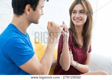 Couple Hands Show Little Finger On Sofa In House. Romantic Love Concept. Hand To Pinky Swear, Pinky 