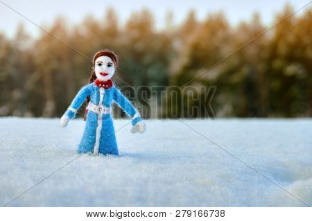 Handmade Doll Needle Felted From A Wool Standing In The Snowy Country Field Utdoors