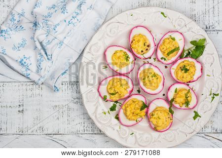 Beet-dyed Deviled Eggs. Easter Stuffed Eggs On White Wooden Background. Copy Space