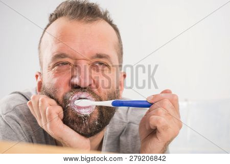 Funnny Guy Taking Care Of His Oral Hygiene, Brushing Teeth During Morning Bathroom Routine.