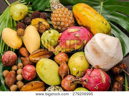 Summer Detox With Vegan Food. Assorted Thai Tropical Fruits On A Dark Wooden Rustic Background.