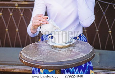 Tips For Healthier Coffee Drinking. Hand Female Adding Pouring Milk To Black Coffee Outdoors Cafe Te
