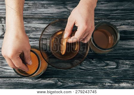 Top View Of Man Putting Kombucha Mushrooms Into Jars