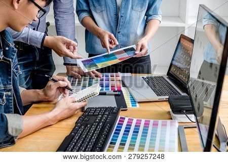 Team Of Young Colleagues Creative Graphic Designer Working On Color Selection And Drawing On Graphic