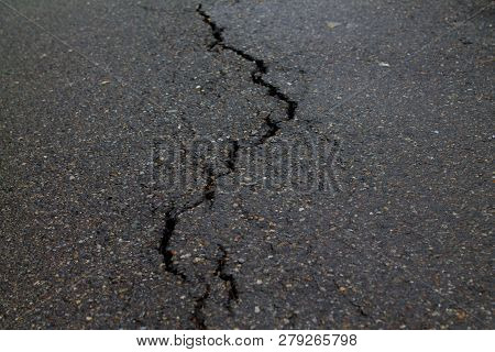 Crack In The Road Pavement After The Rain.