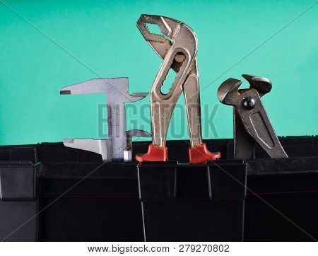 Garage Plastic Tool Box With Working Tools Isolated On Blue. Nippers, Wrench, Caliper