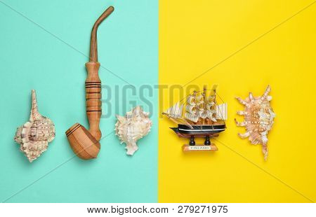 Decorative Ship, Seashells, Chicken Pipe On A Colored Pastel Background. Captain Shipwreck.  Summer 