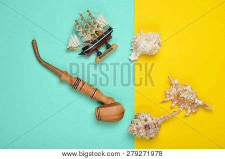 Decorative Ship, Seashells, Chicken Pipe On A Colored Pastel Background. Captain Shipwreck.  Summer 