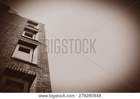 View At Side Of Red Brick Building With Modern Windows On Blue Sky Background. Bremen, Germnay . Ima