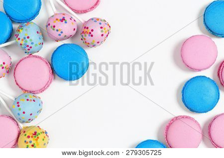 Pink And Blue Macaroons And Cake Pops On White Background. Tasty Almond Cookies. Copy Space. Top Vie