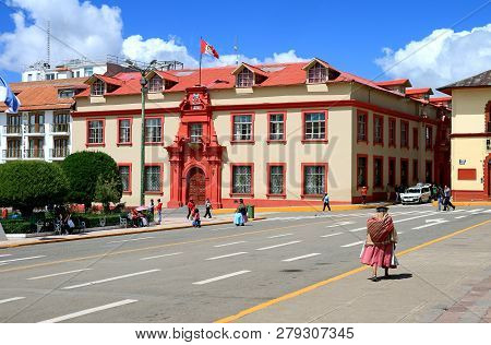 Local Woman Walking At Plaza De Armas Square With The Palacio De Justicia, Stunning Building In The 