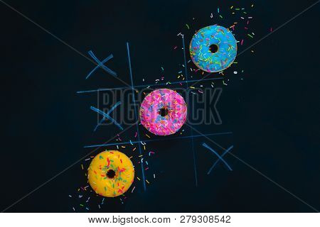 Glazed Donuts Tic-tac-toe Game. Chalk Drawing On A Dark Background With Copy Space. Creative Food Fl