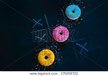 Glazed Donuts Tic-tac-toe Game. Chalk Drawing On A Dark Background With Copy Space. Creative Food Fl