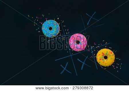Glazed Donuts Tic-tac-toe Game. Chalk Drawing On A Dark Background With Copy Space. Creative Food Fl