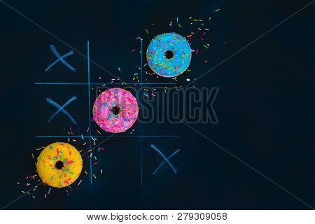 Glazed Donuts Tic-tac-toe Game. Chalk Drawing On A Dark Background With Copy Space. Creative Food Fl