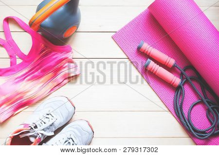 Creative Flat Lay Healthy And Dieting Concept. Fitness Equipments And Cloting In Pink Colour Tone