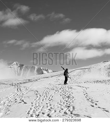Skier With Skis On His Shoulder And Snowy Mountain In Cold Sun Day. Winter Caucasus Mountains, Georg