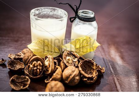 Close Up Of Akhrot Ka Dudh Or Walnut Milk On Wooden Surface With Raw Milk In  A Glass Bottle And Som