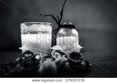 Close Up Of Akhrot Ka Dudh Or Walnut Milk On Wooden Surface With Raw Milk In  A Glass Bottle And Som