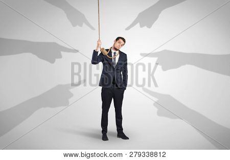 Young businessman trying to suicide with pointing hands concept
