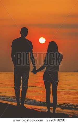 Lovers On The Sea Looking At The Sunset. Selective Focus