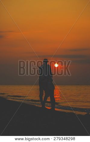 Lovers On The Sea Looking At The Sunset. Selective Focus